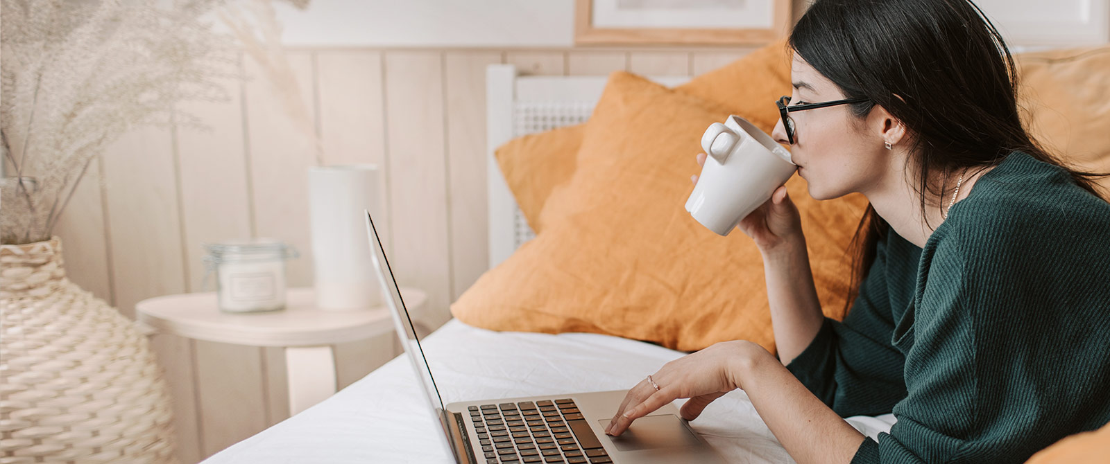 Woman drinking coffee on her computer